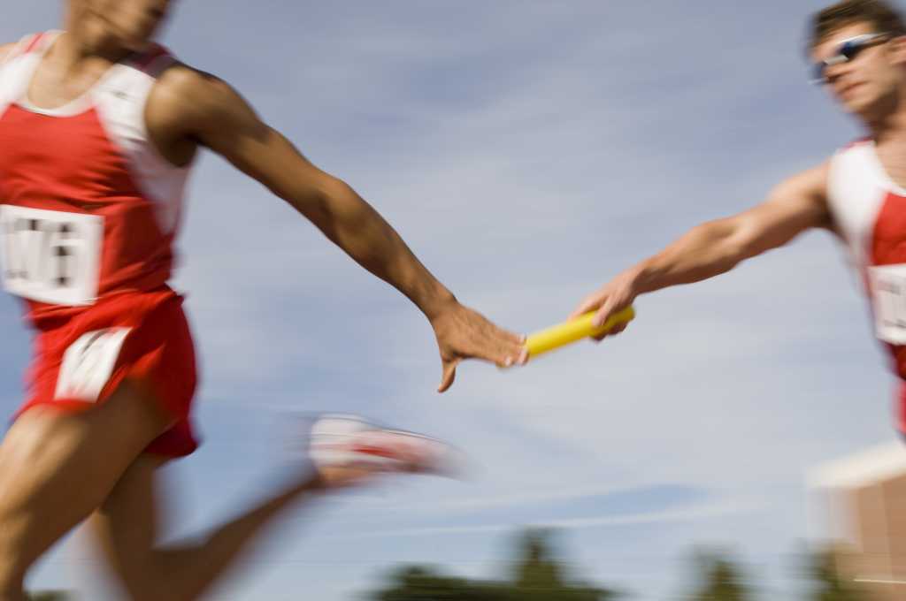 shutterstock 111592973 runners passing baton relay race