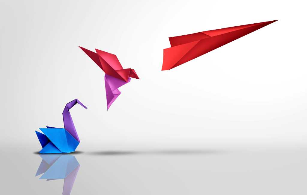 Paper cranes, change, evolution. A colorful paper crane becomes a paper airplane in flight.