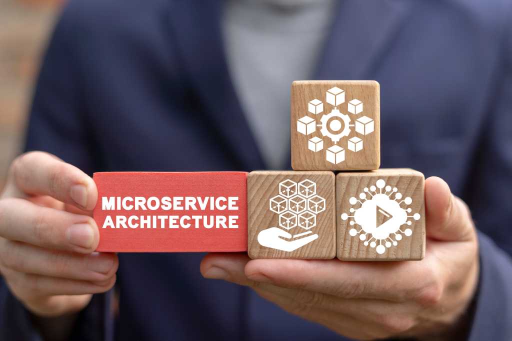 Person holding the building blocks of a microservices architecture